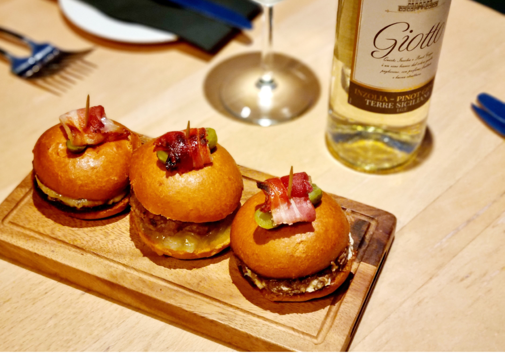 Small burgers with a bottle Pinot Grigio